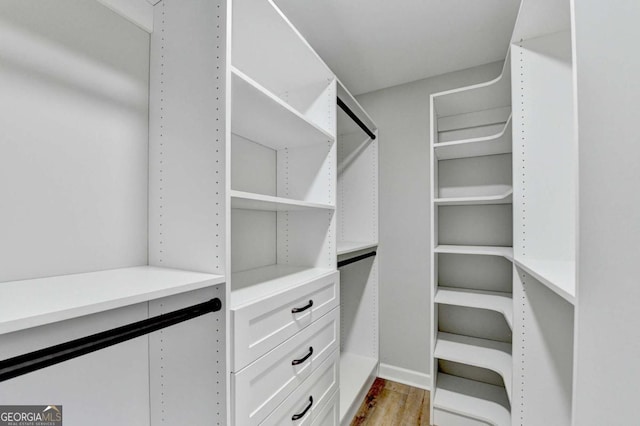 spacious closet featuring light hardwood / wood-style floors