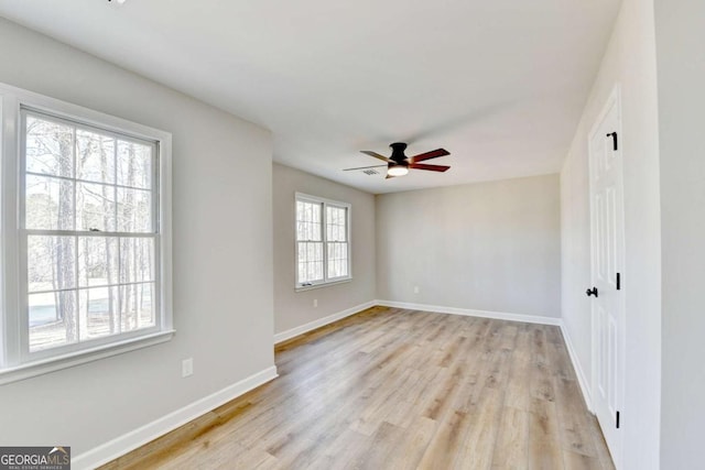 spare room featuring light hardwood / wood-style floors and ceiling fan