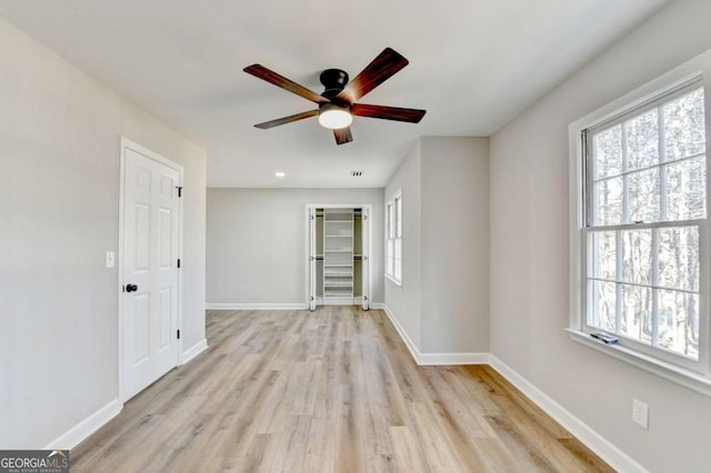 empty room featuring ceiling fan and light hardwood / wood-style flooring