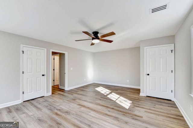 unfurnished bedroom with ceiling fan and light hardwood / wood-style floors