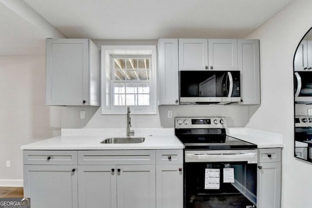 kitchen featuring white cabinetry, stainless steel appliances, and sink