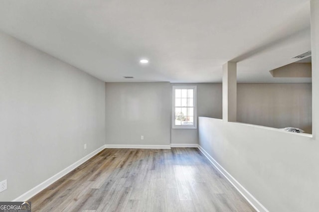 spare room featuring light hardwood / wood-style flooring