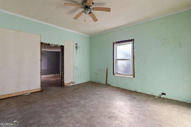 spare room featuring ornamental molding and ceiling fan