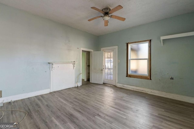 empty room featuring ceiling fan and hardwood / wood-style floors