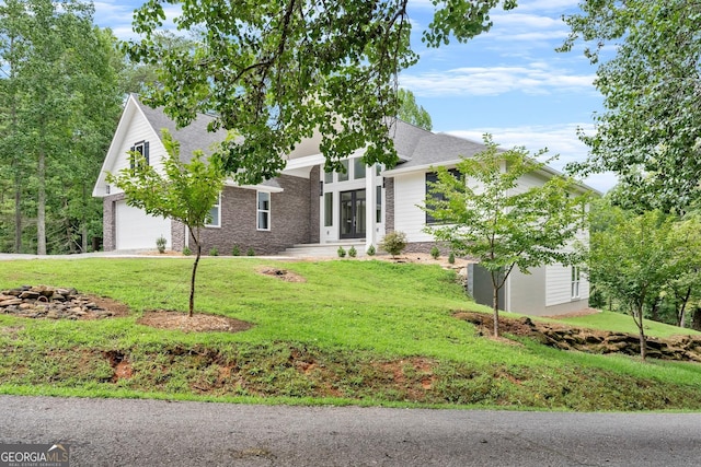 view of front of property featuring a garage and a front yard