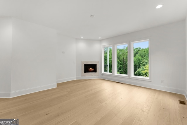 unfurnished living room with light hardwood / wood-style flooring