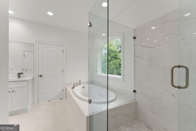 bathroom featuring independent shower and bath and vanity