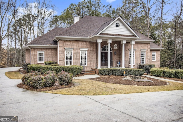 greek revival inspired property featuring covered porch