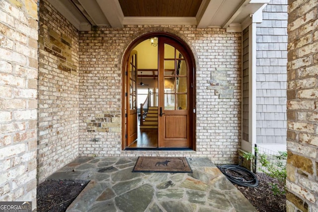 view of exterior entry with brick siding