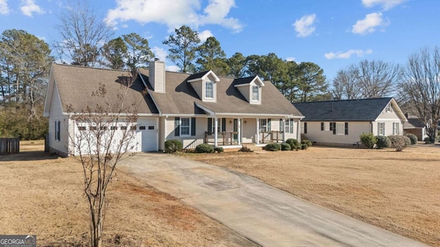 cape cod house with a garage and a porch