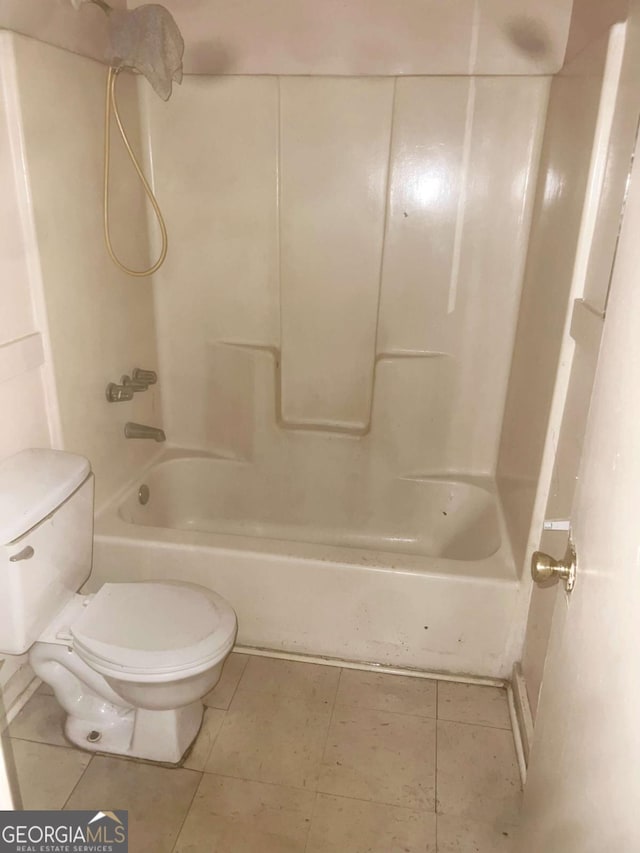 bathroom with tile patterned flooring, shower / bathtub combination, and toilet