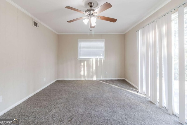 unfurnished room featuring ornamental molding, carpet, and a wealth of natural light