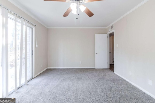 spare room featuring ceiling fan, ornamental molding, and carpet floors