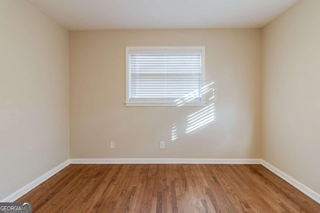 empty room featuring wood-type flooring