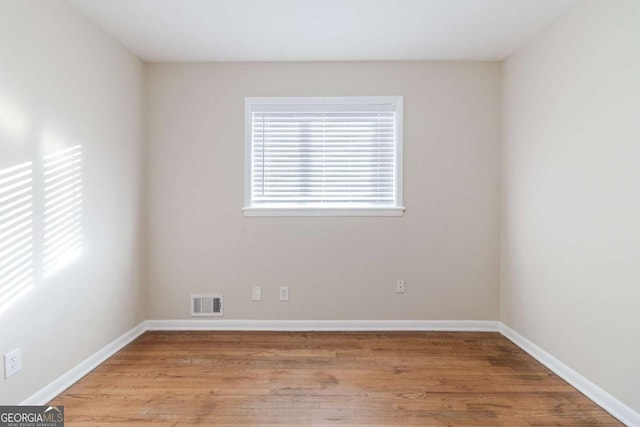 unfurnished room with light hardwood / wood-style flooring