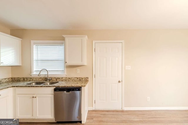 kitchen with white cabinetry, sink, stainless steel dishwasher, light stone counters, and light wood-type flooring