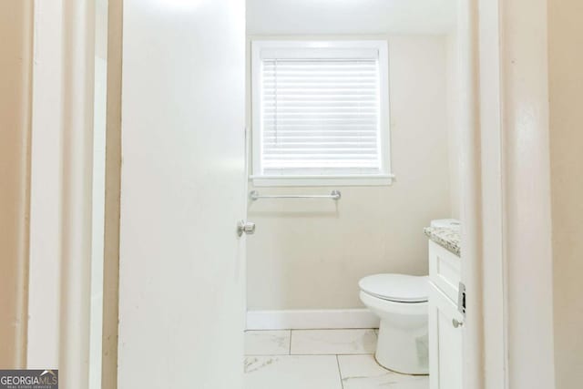 bathroom with vanity and toilet