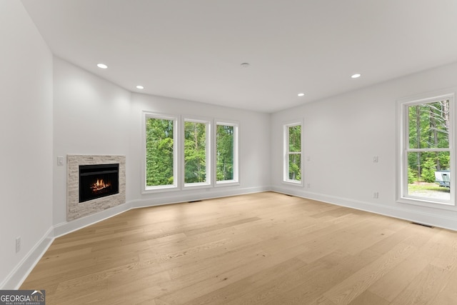 unfurnished living room with plenty of natural light and light wood-type flooring