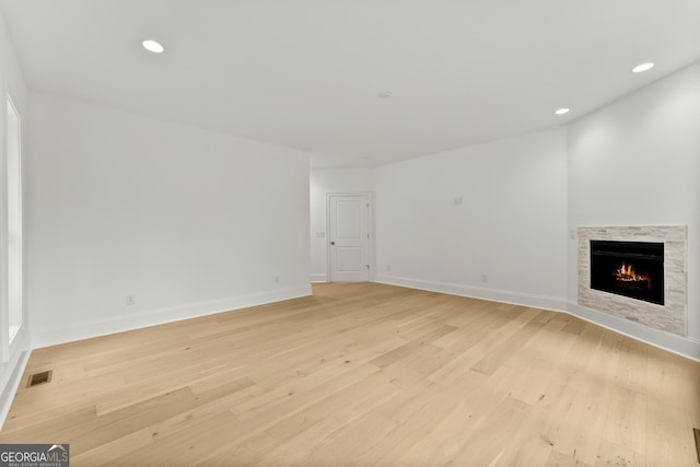 unfurnished living room featuring light wood-type flooring