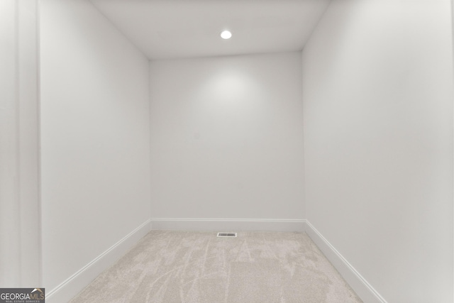 unfurnished room featuring light carpet