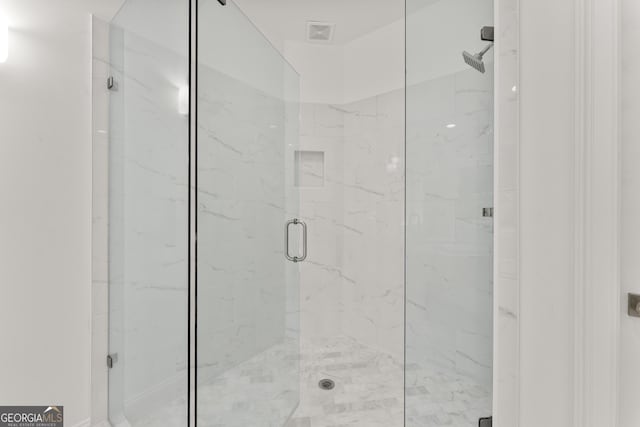 bathroom with a shower with shower door