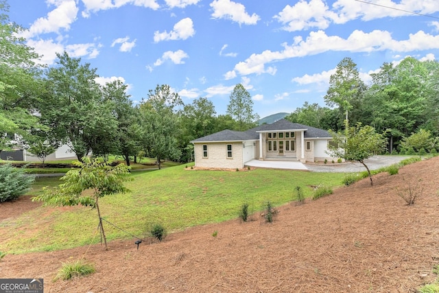 back of house with a yard and a patio area