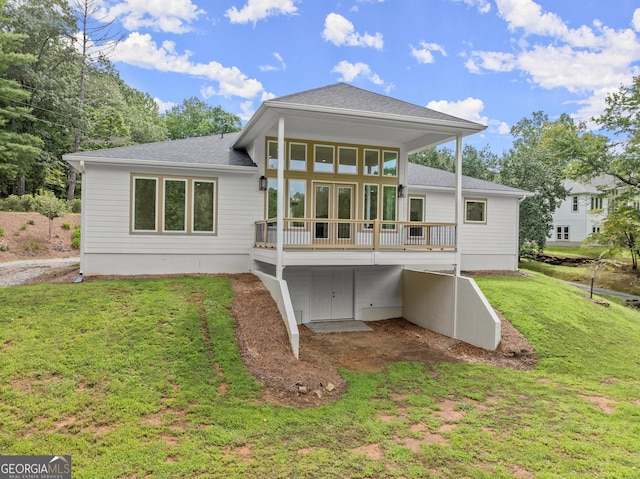 back of property featuring french doors and a yard