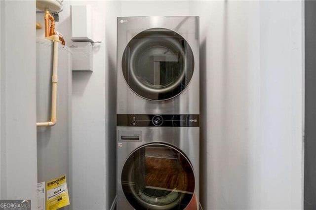 laundry room with stacked washer / drying machine