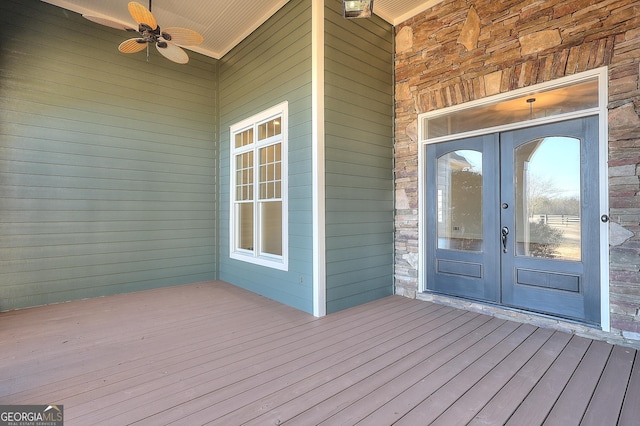 property entrance with french doors, ceiling fan, and a wooden deck