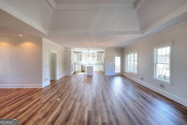 unfurnished living room with crown molding and dark hardwood / wood-style floors