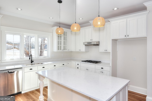 kitchen featuring appliances with stainless steel finishes, decorative light fixtures, sink, white cabinets, and light stone countertops