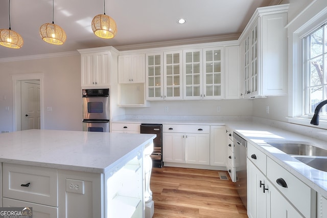 kitchen featuring stainless steel appliances, a kitchen island, and pendant lighting