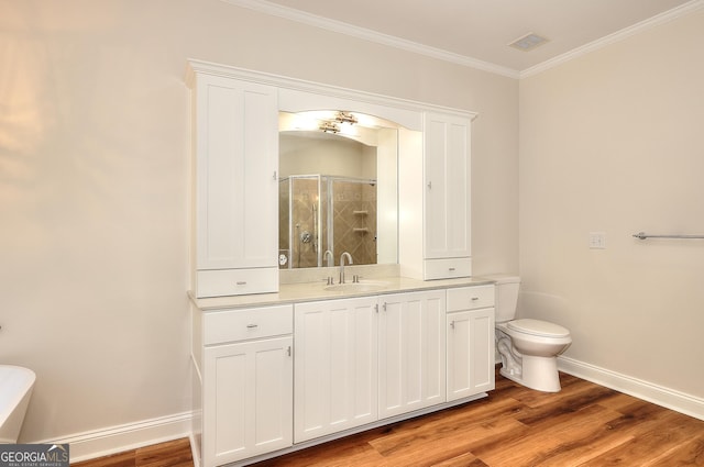 bathroom with an enclosed shower, hardwood / wood-style floors, ornamental molding, and toilet