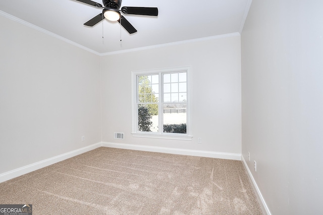 carpeted spare room with ceiling fan and ornamental molding