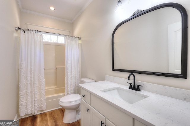 full bathroom featuring shower / tub combo with curtain, wood-type flooring, ornamental molding, vanity, and toilet