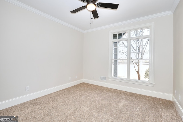 empty room with ornamental molding, carpet floors, and ceiling fan