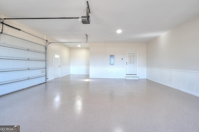 garage featuring a garage door opener and electric panel