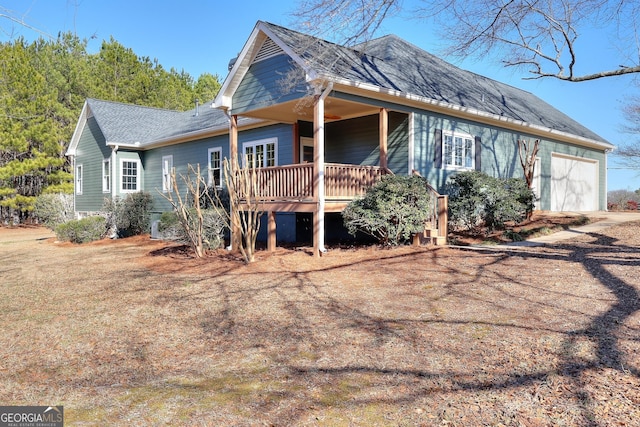 view of front facade with a wooden deck and a garage