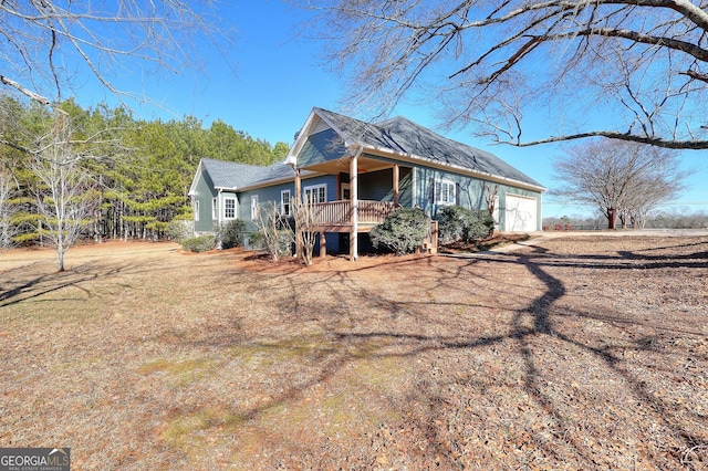 single story home with a garage and a deck