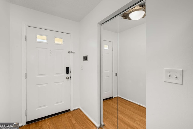 entryway with hardwood / wood-style flooring