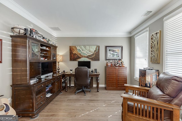 office area with ornamental molding and light hardwood / wood-style floors