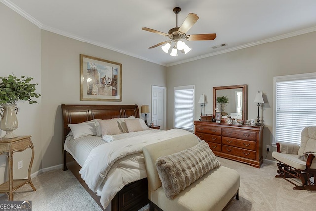 bedroom with crown molding, light colored carpet, and ceiling fan