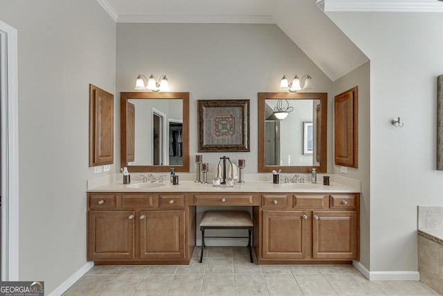 bathroom featuring lofted ceiling, crown molding, vanity, tile patterned flooring, and a washtub