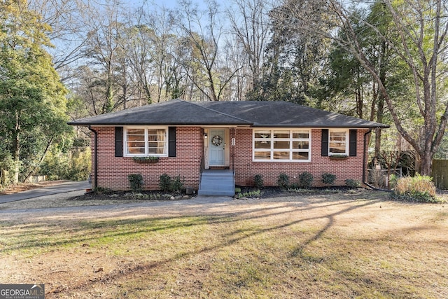 ranch-style home with a front lawn