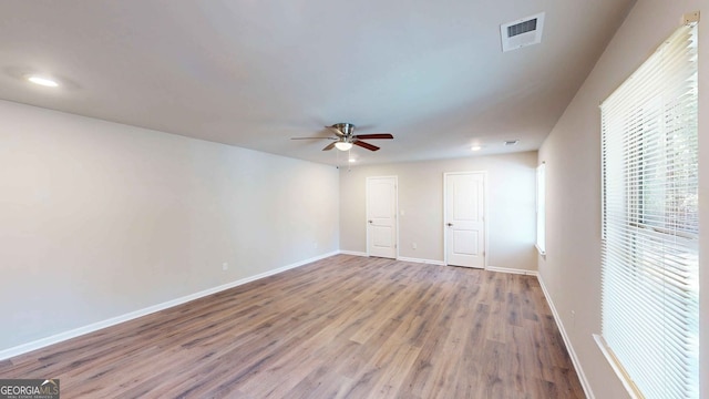 empty room featuring hardwood / wood-style flooring and ceiling fan