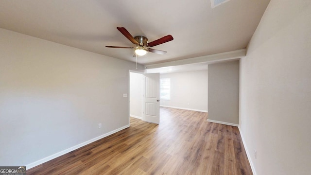 spare room with ceiling fan and wood-type flooring