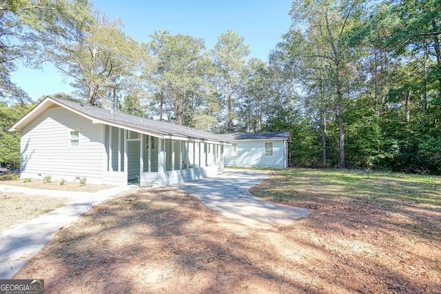 single story home featuring a sunroom