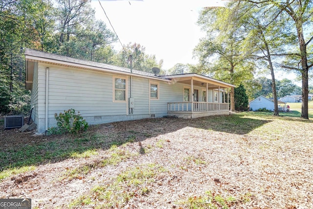 exterior space featuring central AC, covered porch, and a front lawn