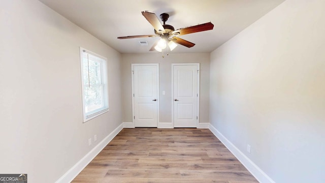 unfurnished bedroom featuring light hardwood / wood-style flooring and ceiling fan