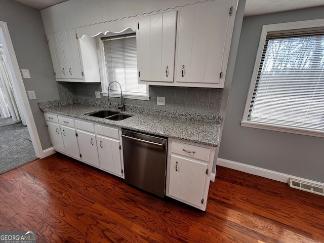 kitchen with visible vents, dark wood finished floors, dishwasher, backsplash, and a sink